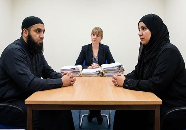Islamic scholar giving marriage or family counseling to a couple during consultation