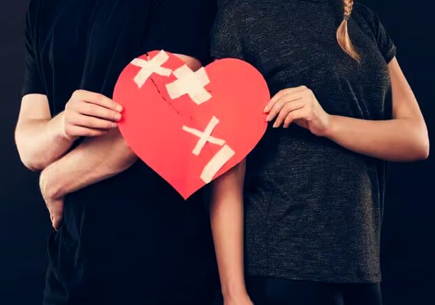 Broken red heart symbolizing love problems, breakup, and emotional pain.